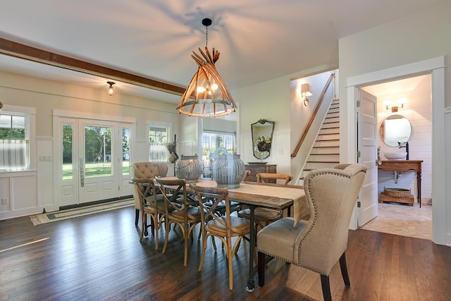 dining room with beamed ceiling and dark wood-type flooring