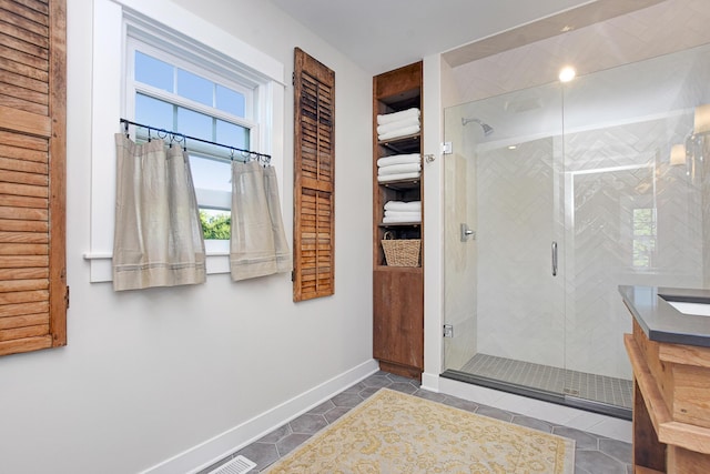 bathroom with tile patterned floors, a wealth of natural light, and an enclosed shower