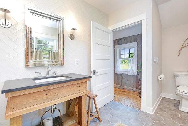 bathroom featuring decorative backsplash, tile patterned floors, vanity, and toilet