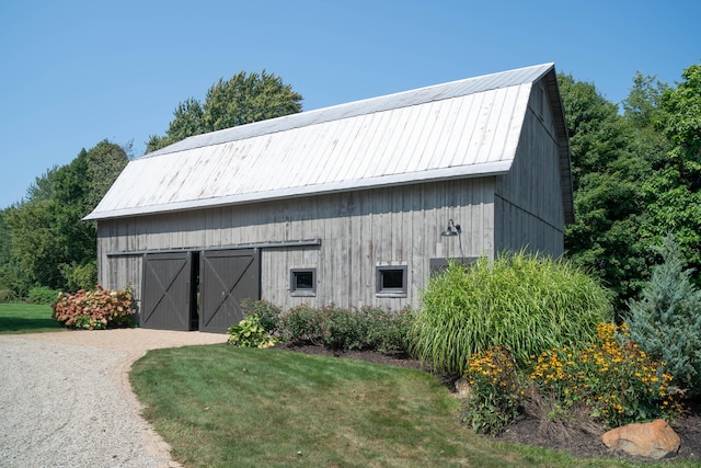 view of outdoor structure featuring a lawn