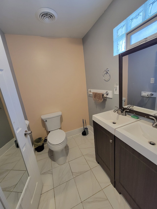 bathroom featuring toilet, tile patterned floors, and vanity