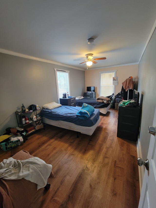 bedroom with ornamental molding, ceiling fan, and wood-type flooring