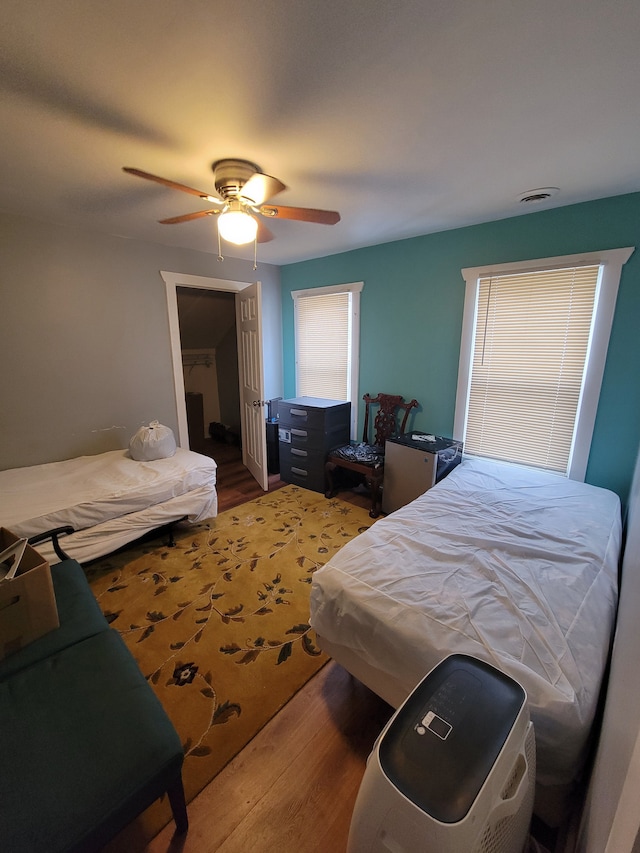 bedroom with wood-type flooring and ceiling fan