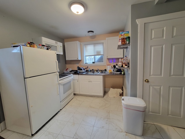 kitchen featuring white appliances, white cabinets, and sink