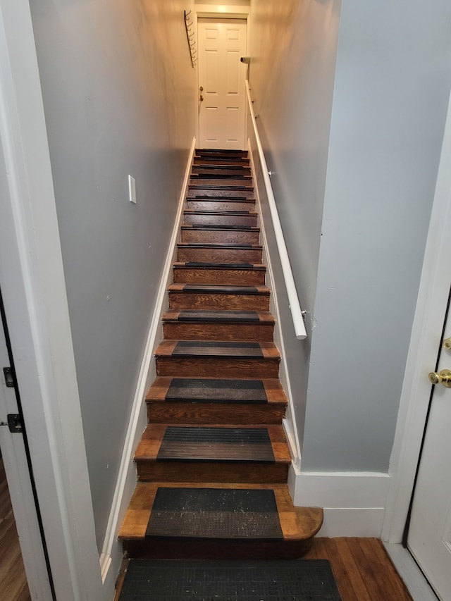 staircase with wood-type flooring