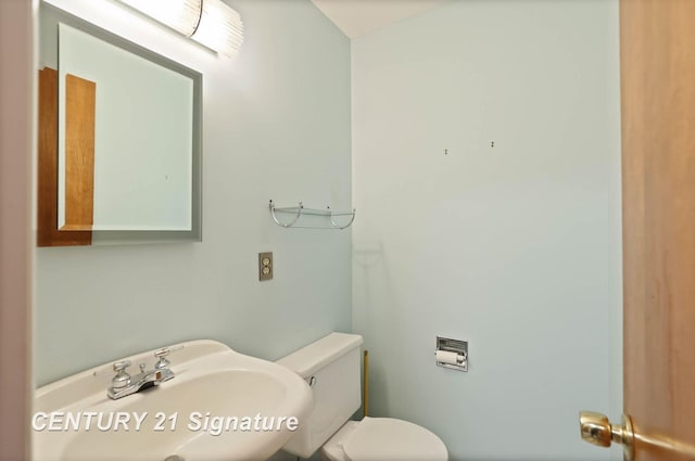 bathroom featuring toilet and sink