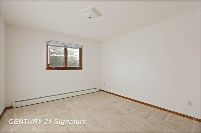 carpeted spare room featuring baseboard heating