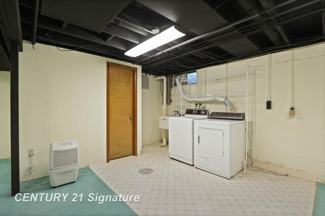 clothes washing area with washer and clothes dryer