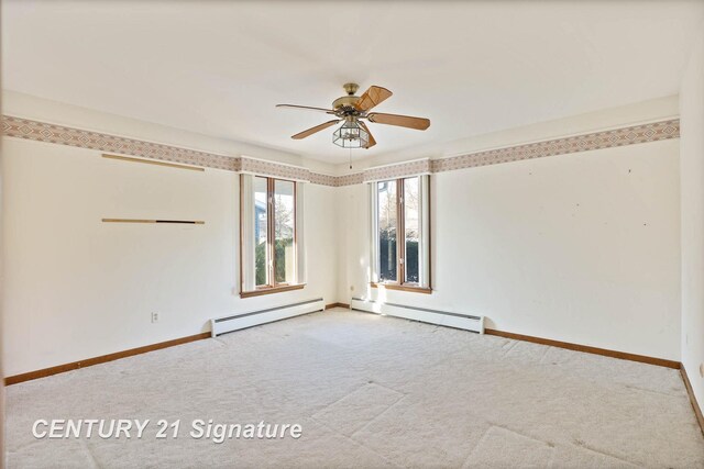 carpeted spare room featuring ceiling fan and baseboard heating