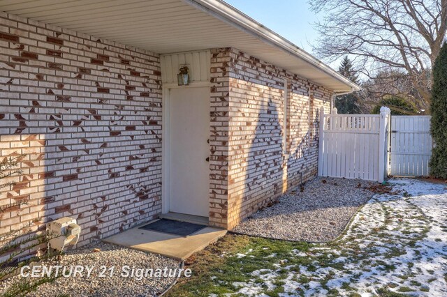 view of snow covered property entrance