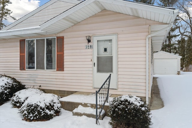 view of snow covered property entrance