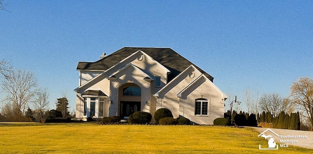 french provincial home featuring a front lawn