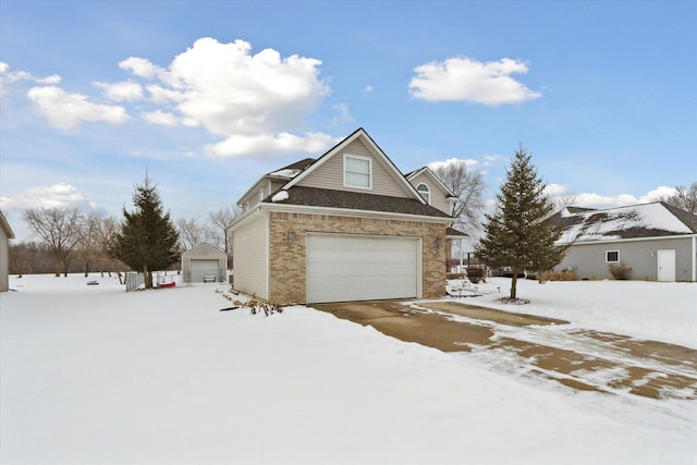 view of front of property with an outbuilding and brick siding