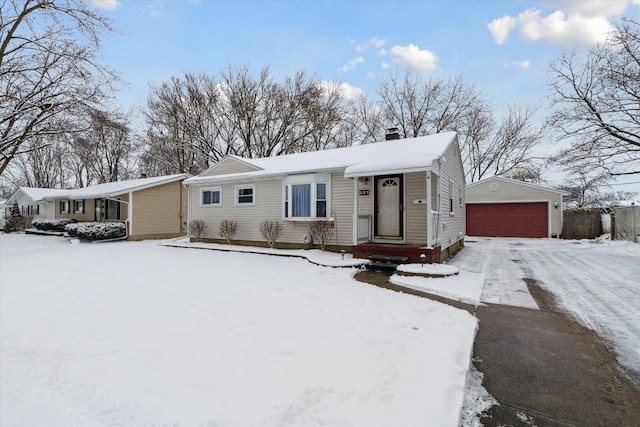 single story home with an outbuilding and a garage