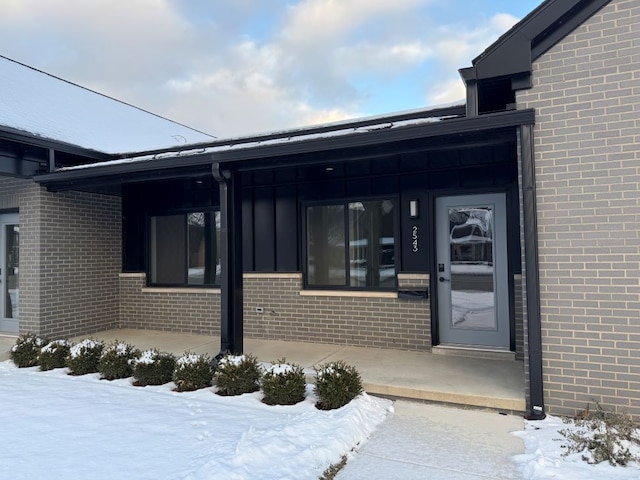 view of snow covered property entrance