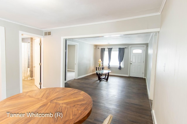 foyer with crown molding and dark wood-type flooring