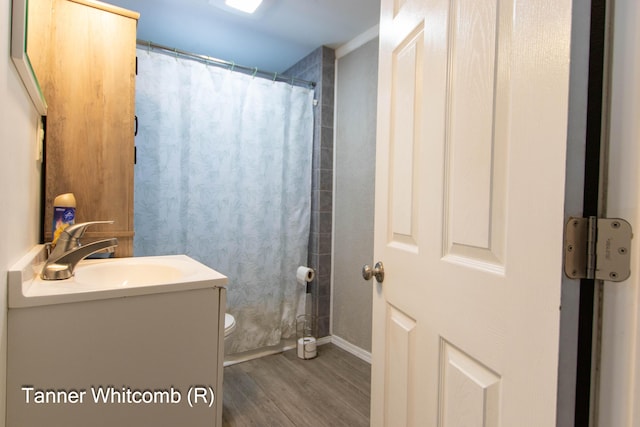 bathroom with a shower with shower curtain, toilet, vanity, and hardwood / wood-style flooring