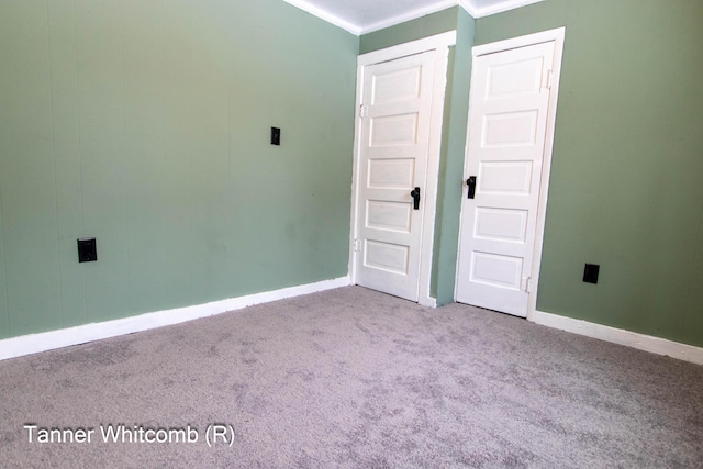 unfurnished bedroom with light carpet and crown molding