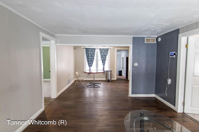 entrance foyer with ornamental molding and dark wood-type flooring