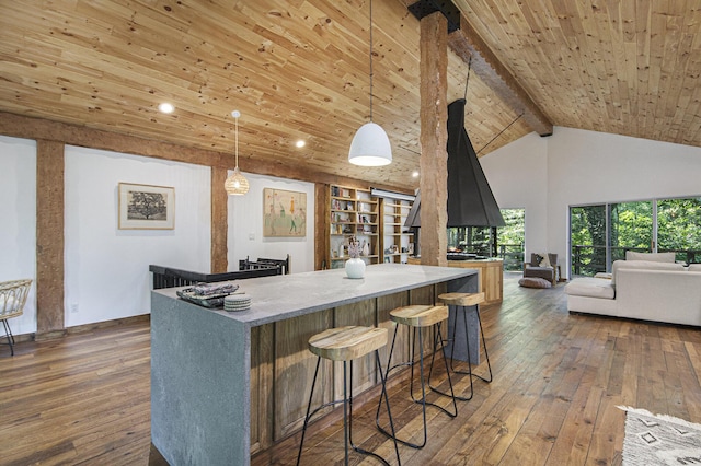 kitchen with wood ceiling, dark wood-type flooring, beam ceiling, decorative light fixtures, and high vaulted ceiling