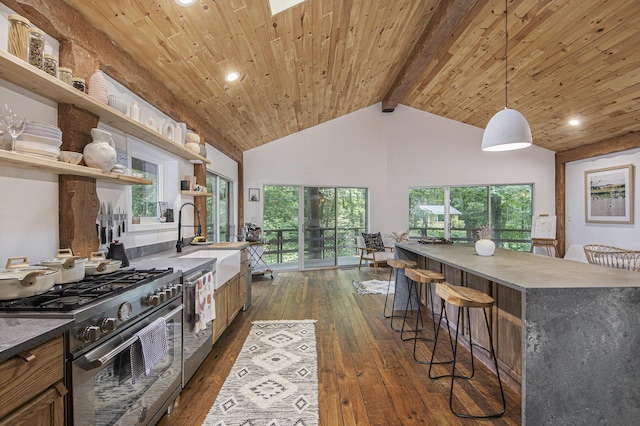 kitchen with pendant lighting, sink, beamed ceiling, wood ceiling, and stainless steel appliances