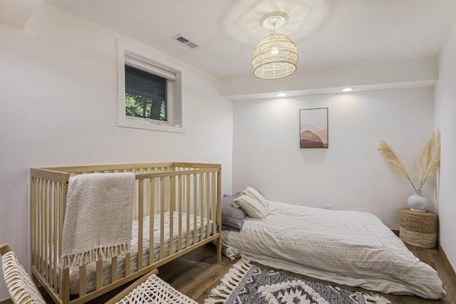 bedroom with dark hardwood / wood-style flooring