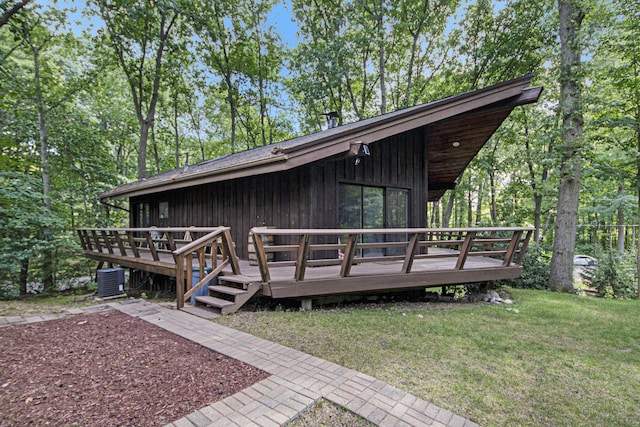 exterior space featuring a yard, central AC unit, and a deck