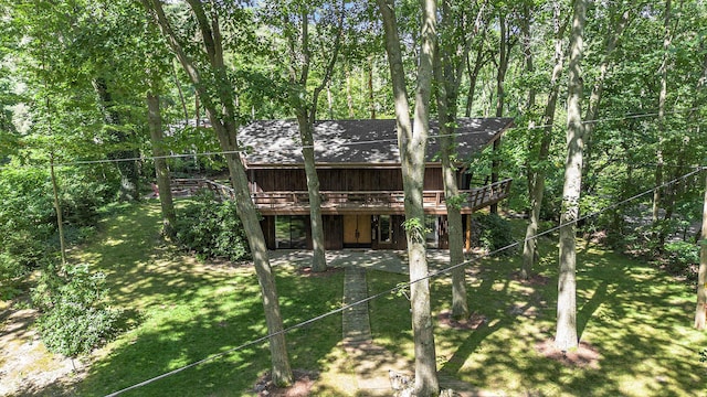 back of property with a lawn, a deck, and a patio