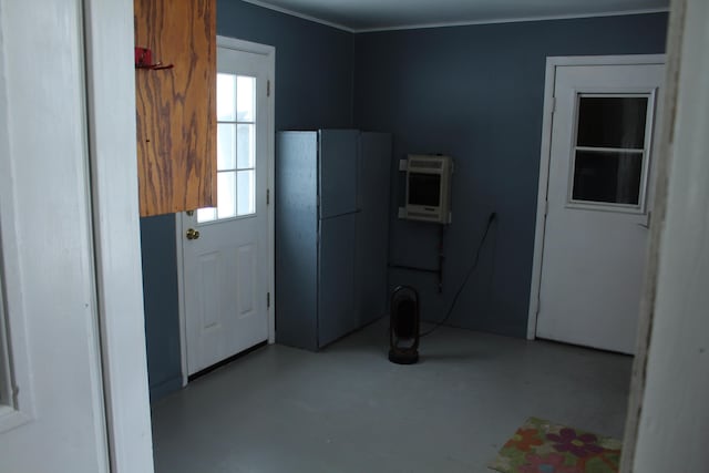 8142 W 32nd Rd, Harrietta, MI 49638 - kitchen featuring heating unit, freestanding refrigerator, ornamental molding, and concrete floors