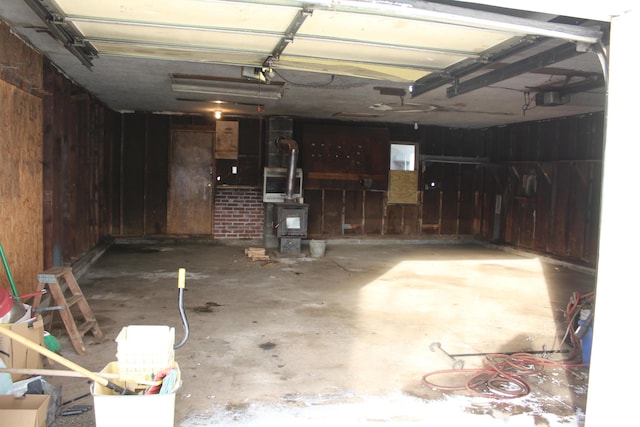 8142 W 32nd Rd, Harrietta, MI 49638 - garage with wooden walls and a garage door opener