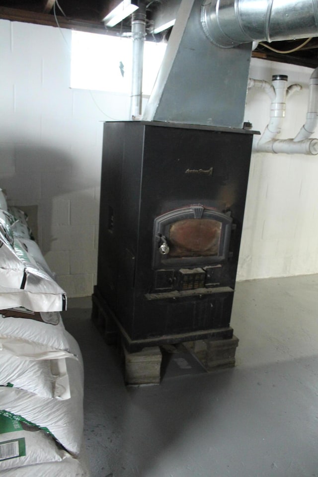 8142 W 32nd Rd, Harrietta, MI 49638 - basement view of a wood stove and finished concrete flooring