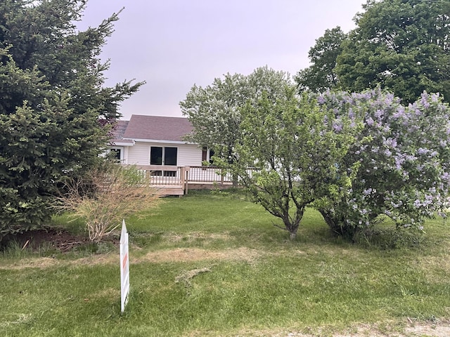 8142 W 32nd Rd, Harrietta, MI 49638 - view of green lawn with a wooden deck