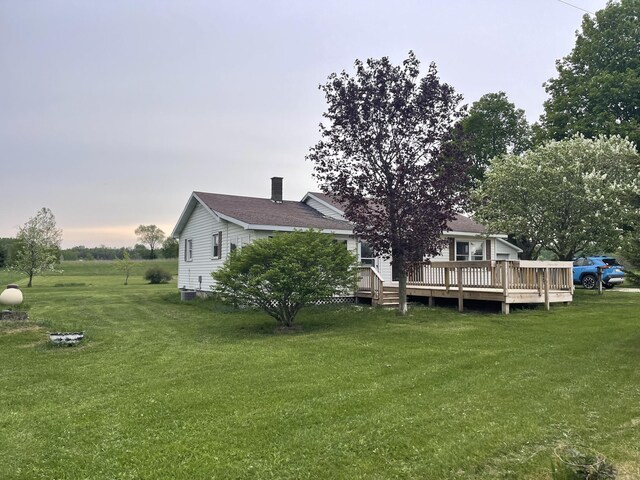 8142 W 32nd Rd, Harrietta, MI 49638 - rear view of house with a wooden deck and a lawn