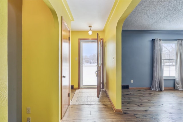 entrance foyer with wood-type flooring and a textured ceiling