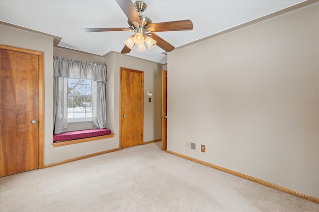 unfurnished bedroom with ceiling fan and light carpet