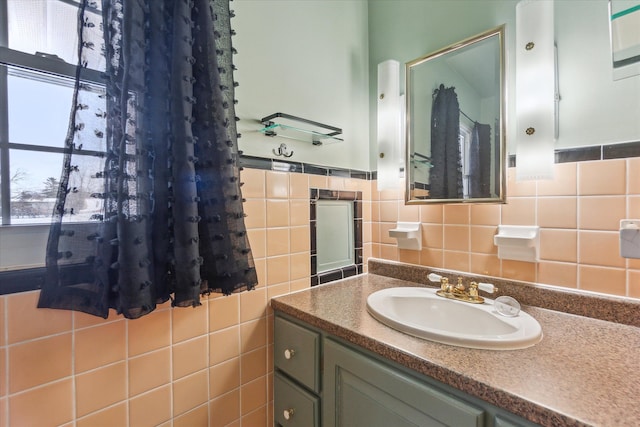 bathroom with vanity and tile walls