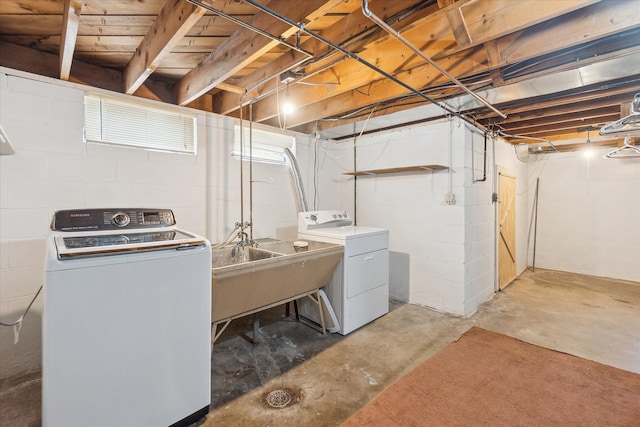 washroom featuring washing machine and dryer and sink