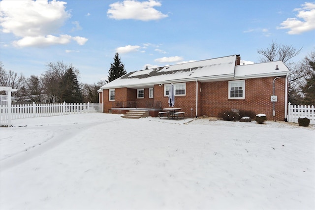 view of snow covered rear of property