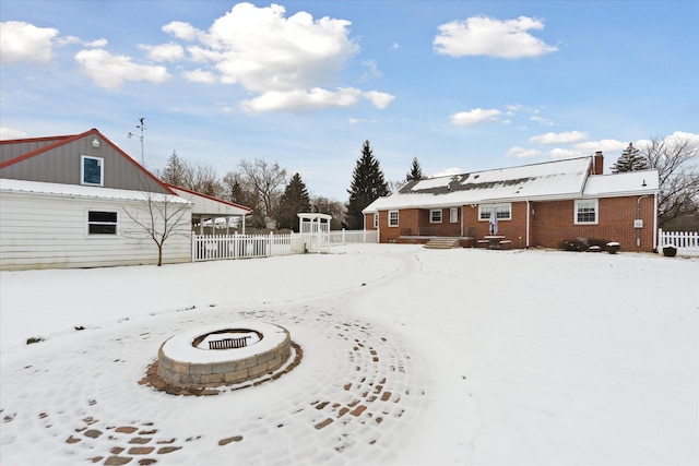 yard covered in snow with a fire pit