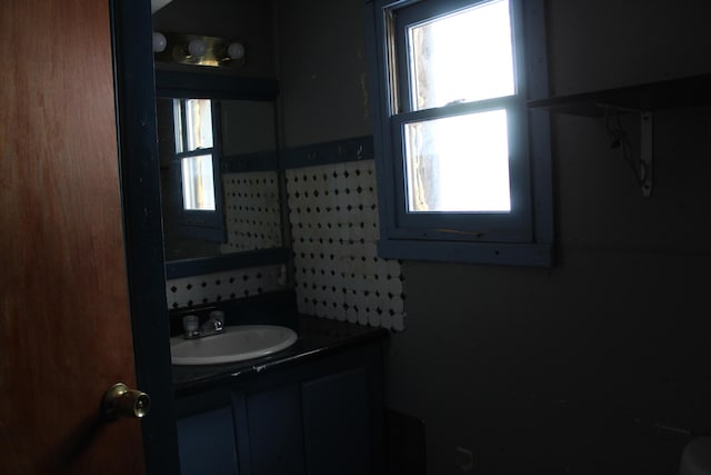 bathroom with decorative backsplash and vanity