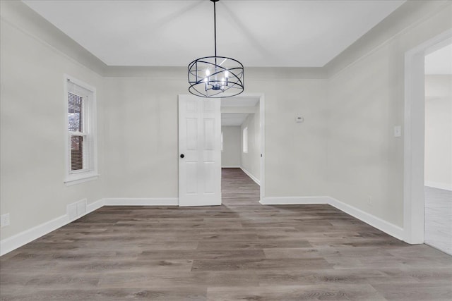 unfurnished dining area featuring hardwood / wood-style floors