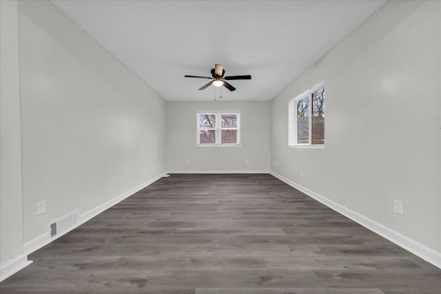 spare room with dark hardwood / wood-style floors and ceiling fan