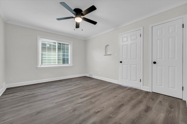 unfurnished bedroom featuring wood-type flooring, crown molding, and ceiling fan