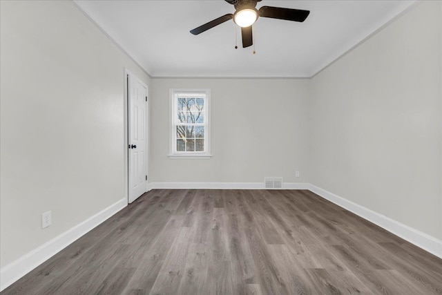 spare room featuring hardwood / wood-style floors, ornamental molding, and ceiling fan