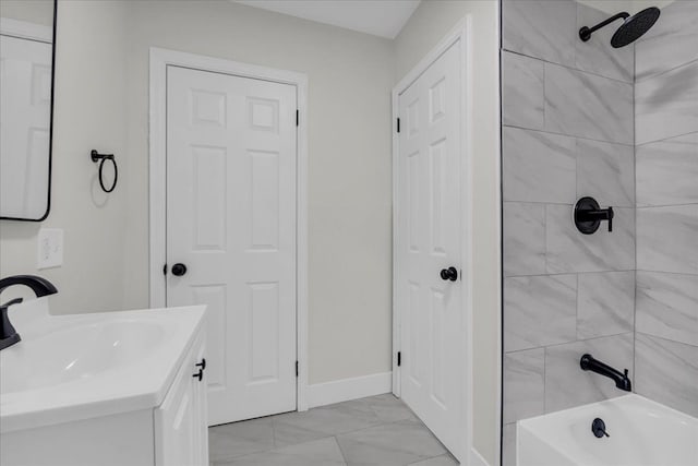 bathroom featuring vanity and tiled shower / bath combo