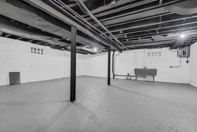 basement featuring sink and electric panel