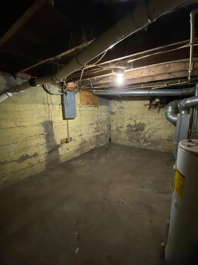 basement featuring electric water heater and electric panel