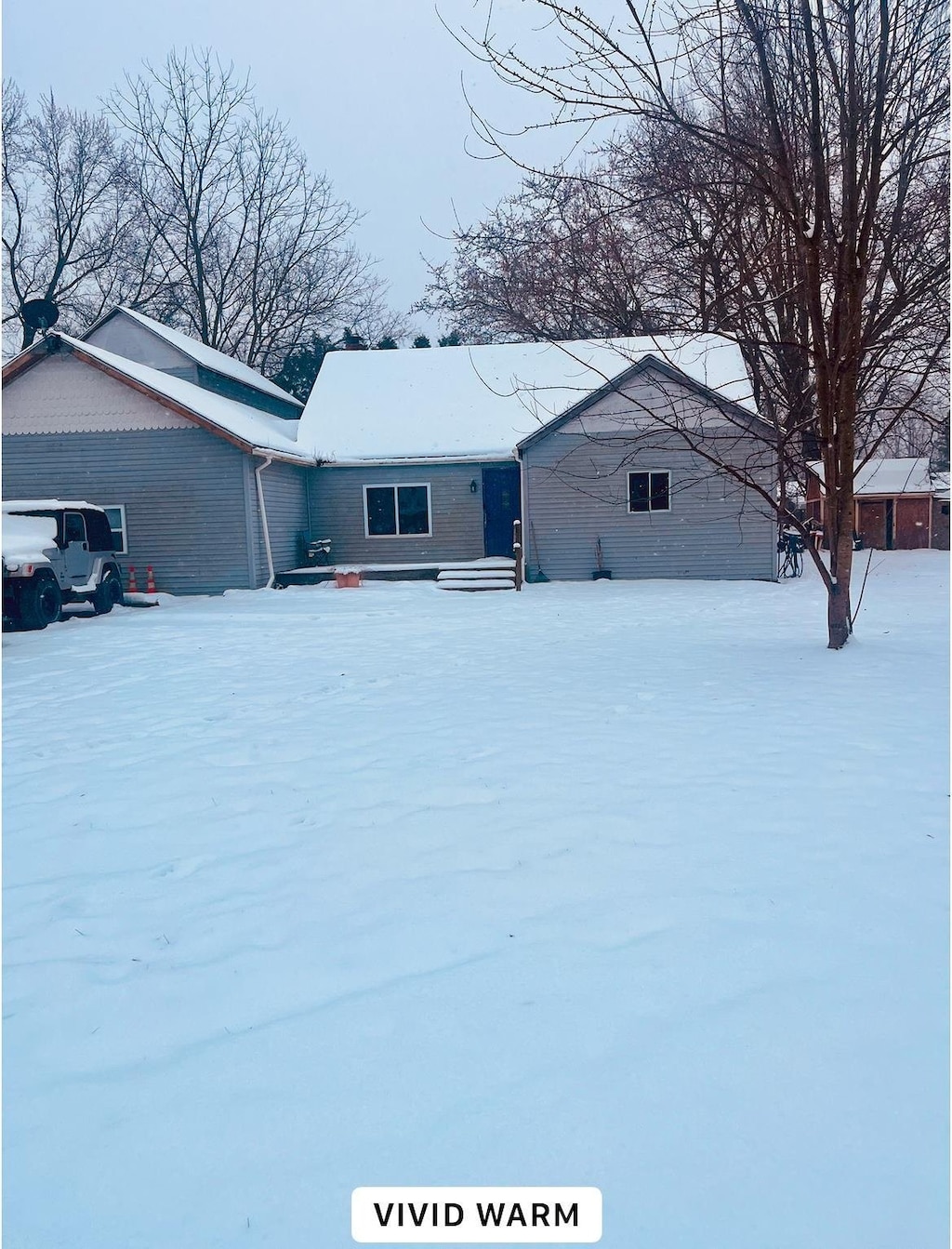 view of snow covered rear of property