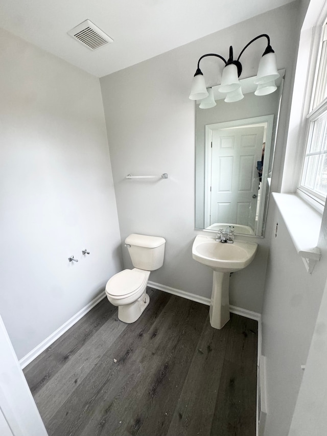 bathroom featuring hardwood / wood-style flooring and toilet