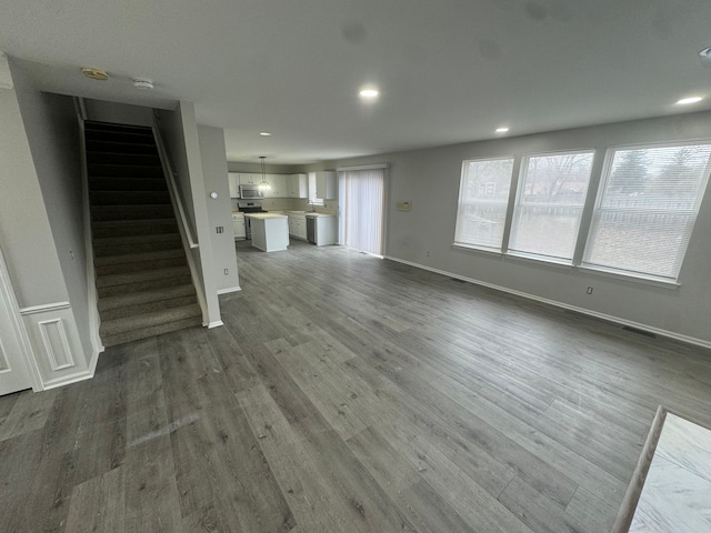 unfurnished living room with dark hardwood / wood-style floors